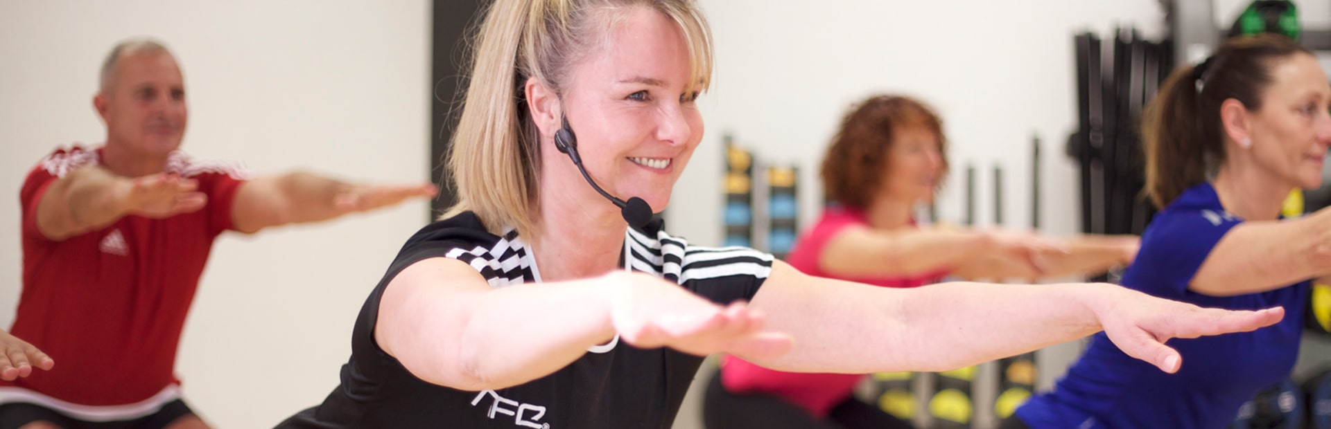 Exercise to music instructor leading class in HFE shirt