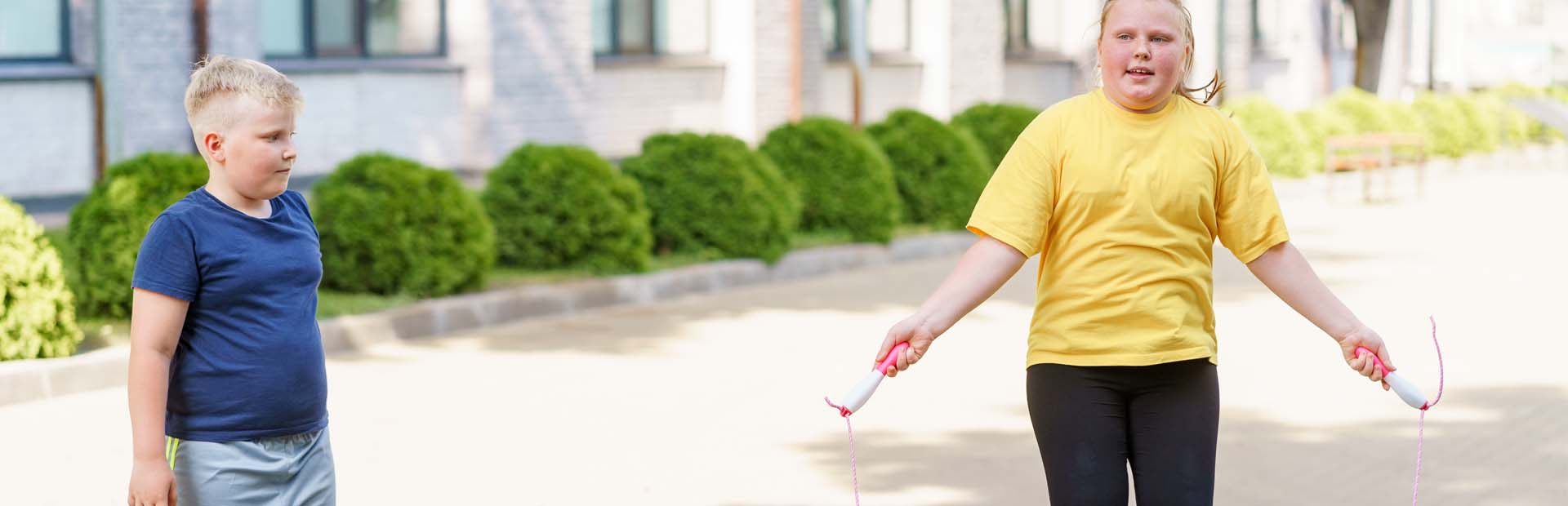 Child skipping outside with skipping rope