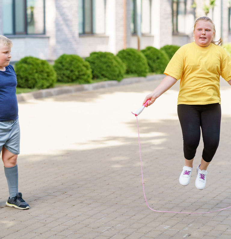 Child skipping outside with skipping rope