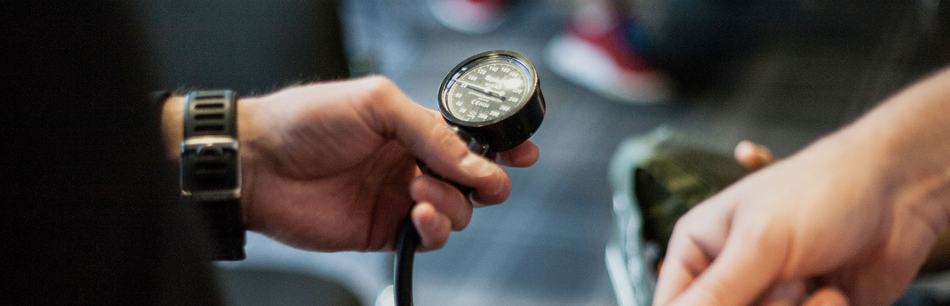 exercise referral specialist holding blood pressure monitor