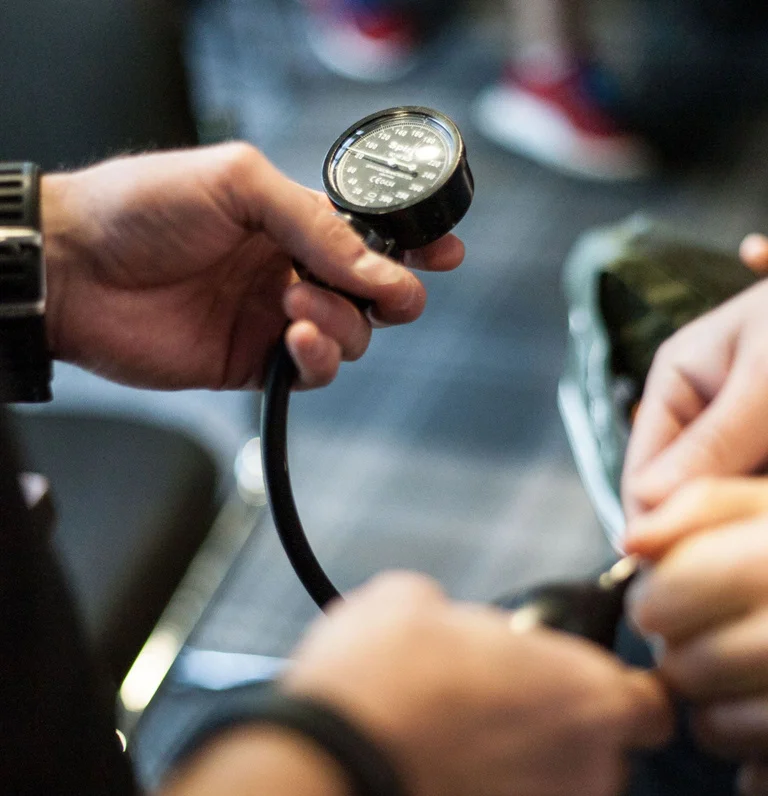 exercise referral specialist holding blood pressure monitor