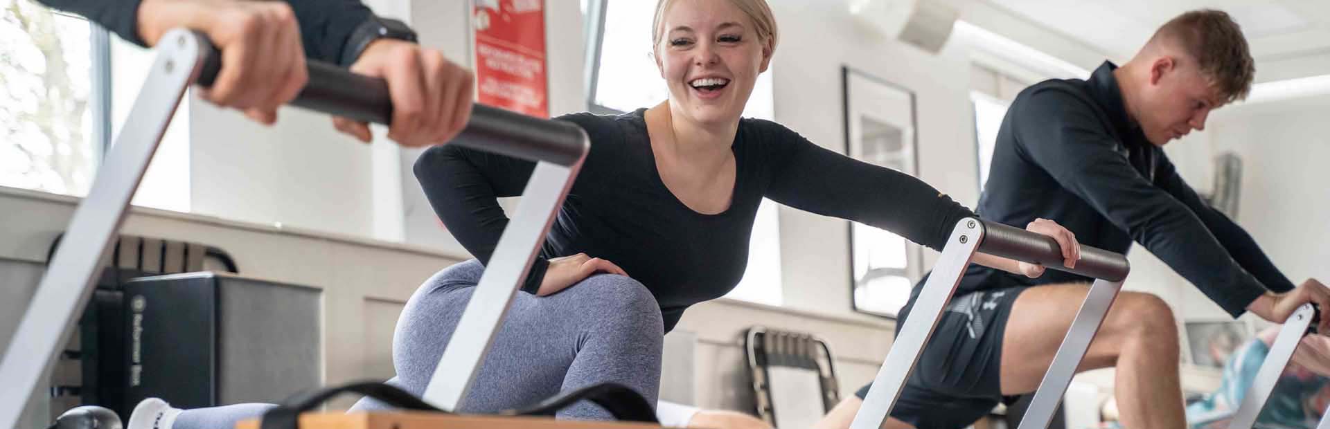 Pilates class member smiling on reformer