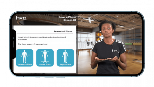 Physiotherapist delivering Pilates lecture shown on iPhone