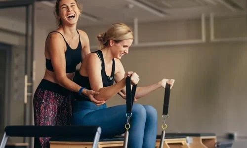 Pilates teacher on reformer