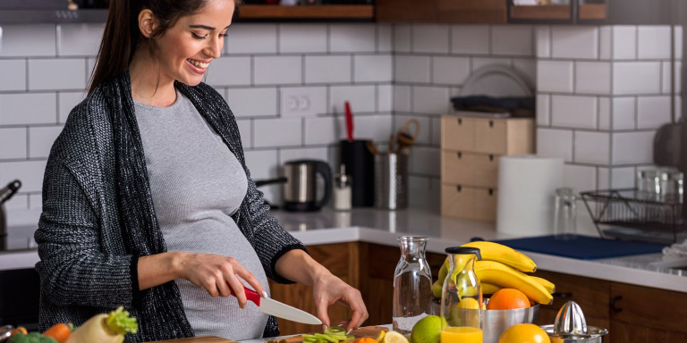 pregnant lady in kitchen cooking