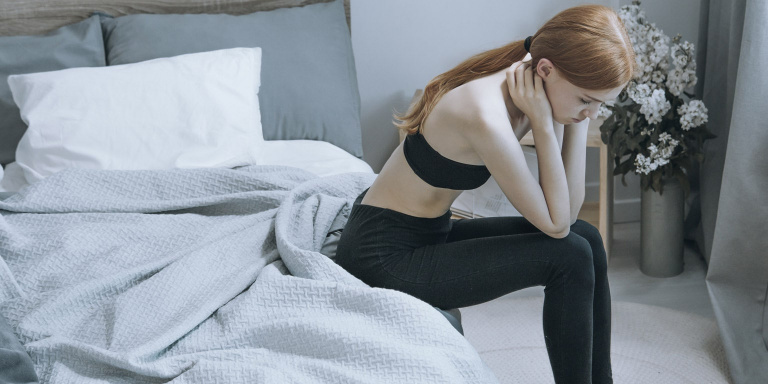 girl with eating disorder on bed