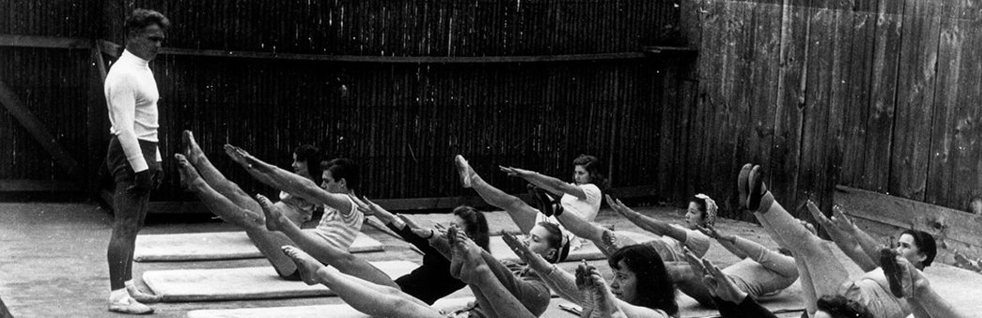 Joseph Pilates conducting a mat-based Pilates class