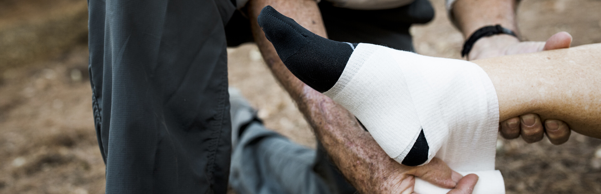 bandage being wrapped round an ankle injury