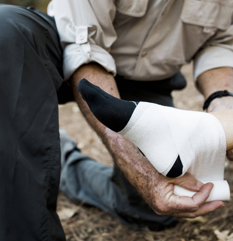 ankle injury being wrapped with a bandage
