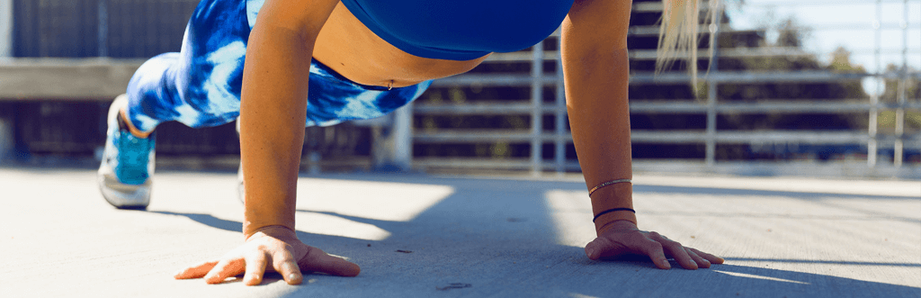 woman doing press ups outdoors