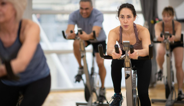 Female group indoor cycling instructor