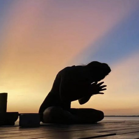 Zoe R - Yoga pose on deck with sunset background