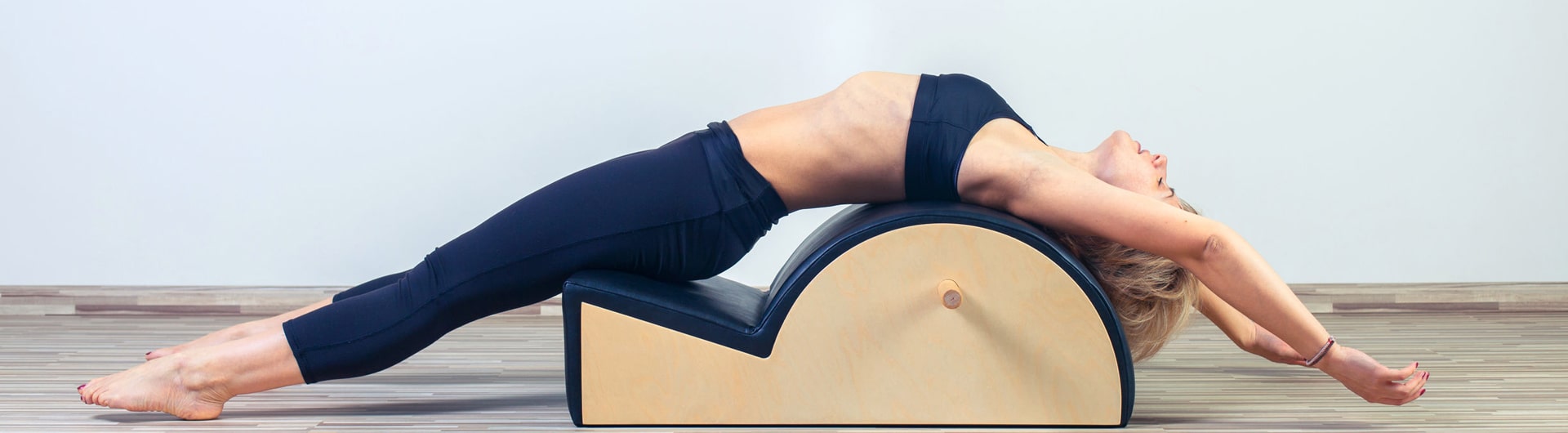 A person using the Pilates Spine Corrector.