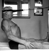Joseph Pilates, the founder of Pilates, using his reformer apparatus.