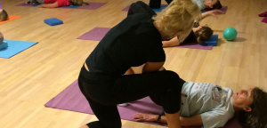 Ruth Hoyle helping a member of her Pilates class with an exercise.