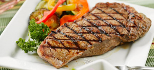 A plate of steak and vegetables