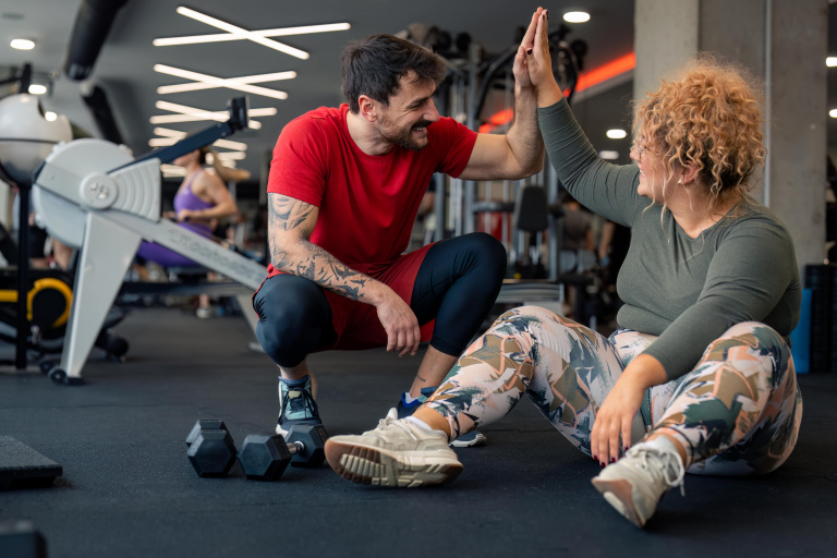 A trainer high-fiving their client