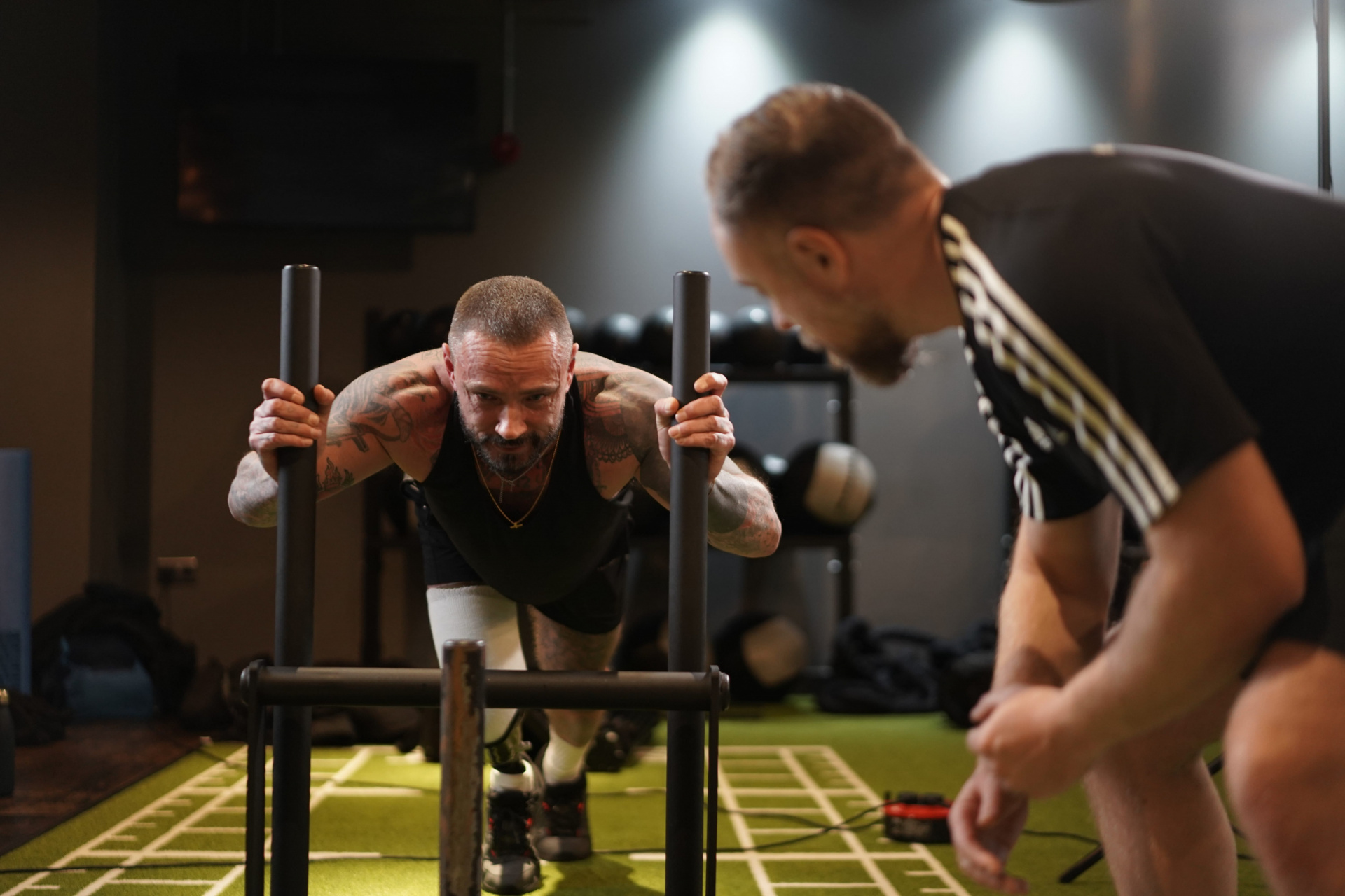 Personal trainer coaching client at the gym