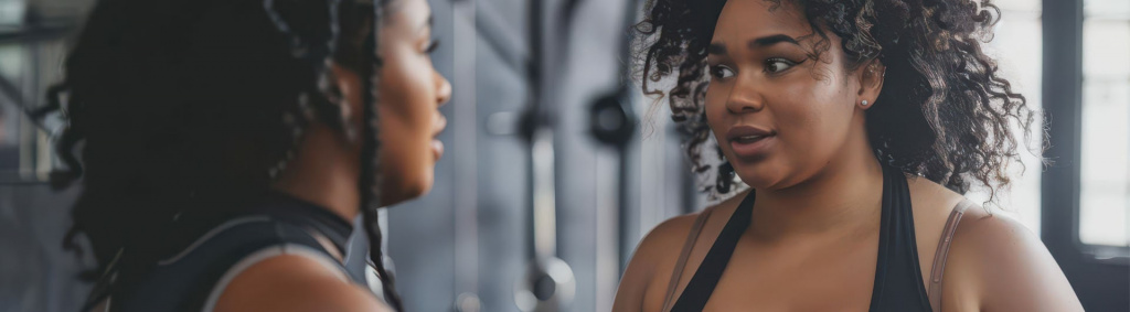 Woman Motivational interviewing a client in the gym