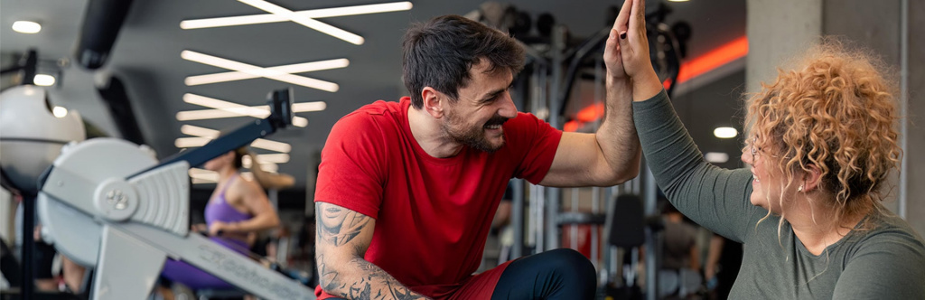 Exercise referral specialist high-fiving client