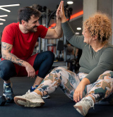 Exercise referral specialist high-fiving client