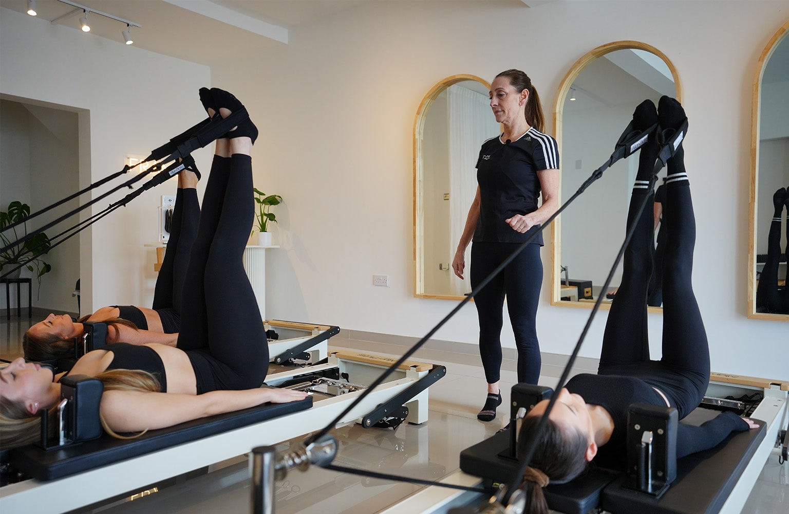 Pilates instructor teaching class