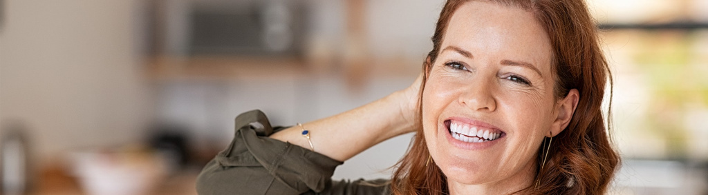 female of menopausal years with hands in air