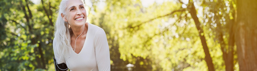 female menopausal woman running in woods