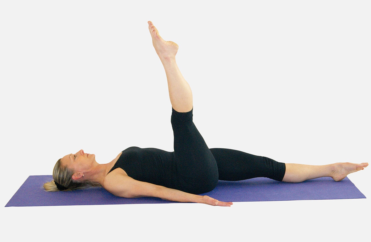 Woman on Pilates mat completing One Leg Circle exercise