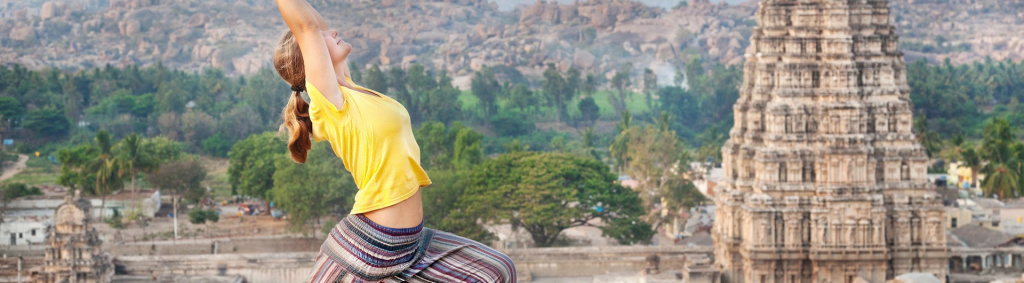 woman performing yoga in front of temple