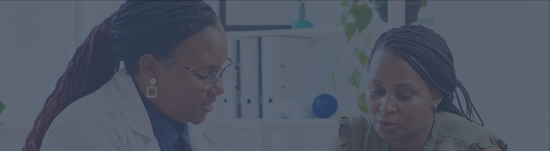 A GP consulting with a female patient A GP consulting with a female patient