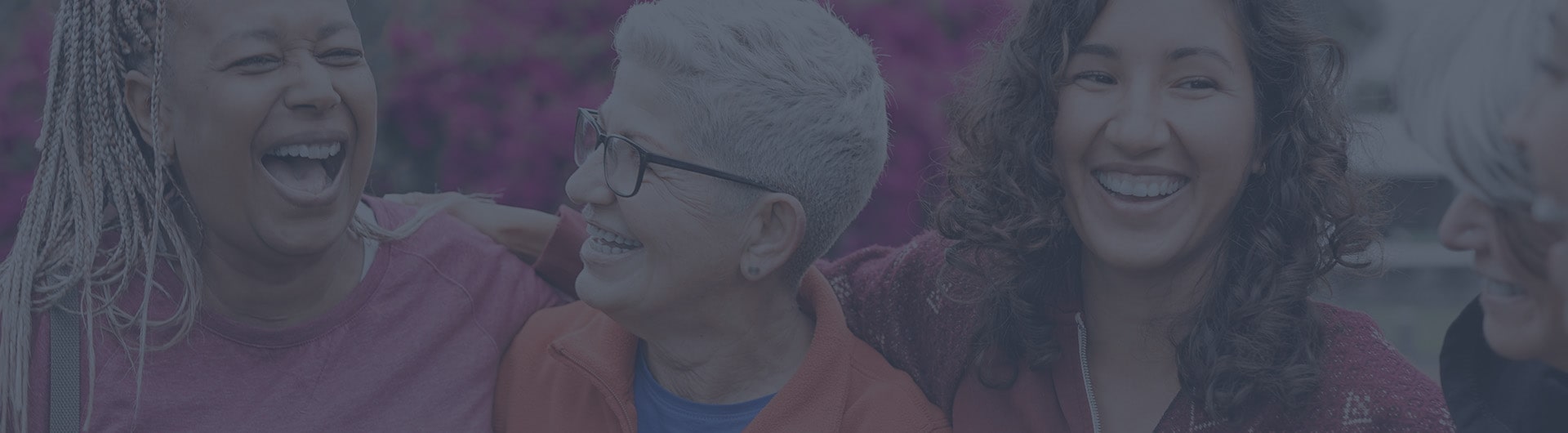 Three women standing side by side smiling Three women standing side by side smiling