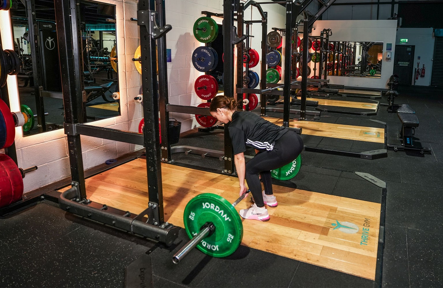 A female in a gym using the conventional deadlift