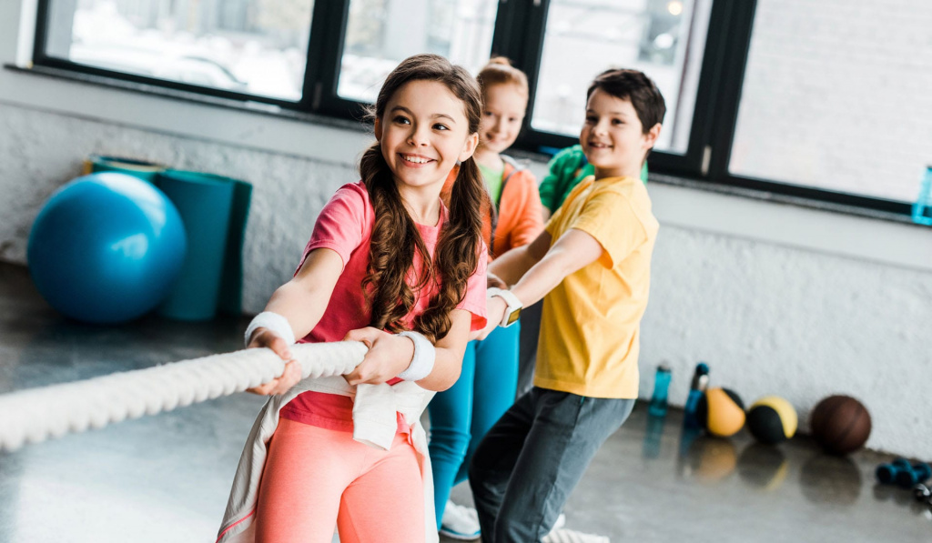 A group of three children exercising.