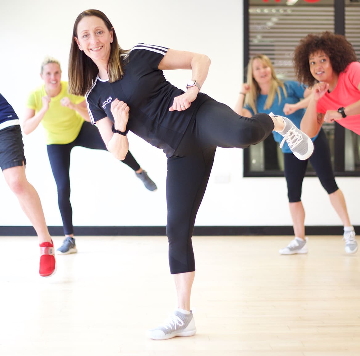 HFE tutor teaching group exercise to music class