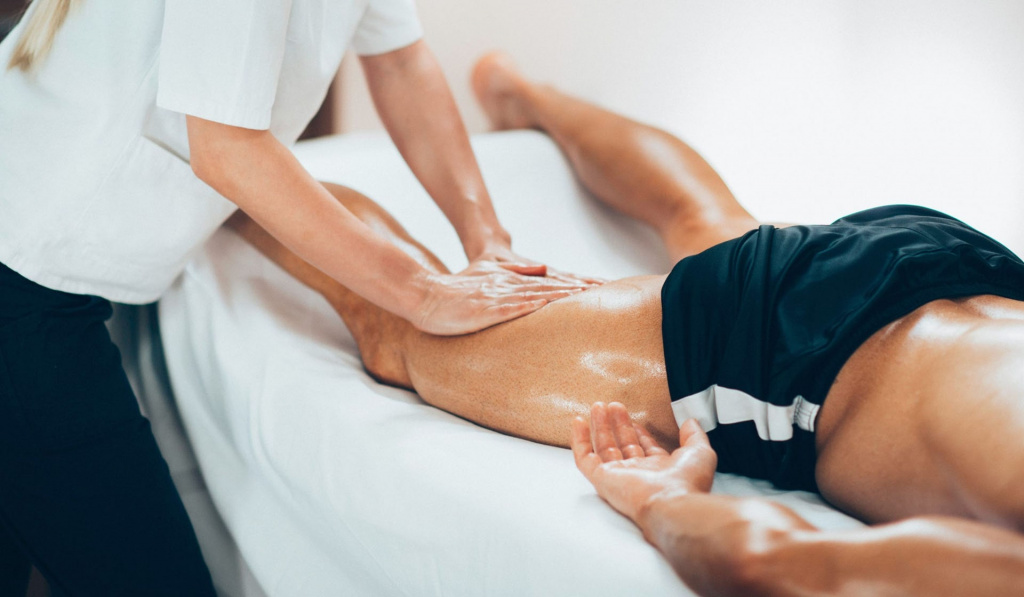 A healthcare provider performing a sports massage on the back of the legs A healthcare provider performing a sports massage on the back of the legs