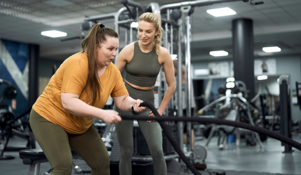 Female trainer in the gym coaching a client