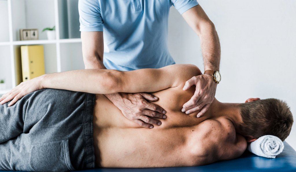 A healthcare provider performing an advanced sports massage on the shoulders
