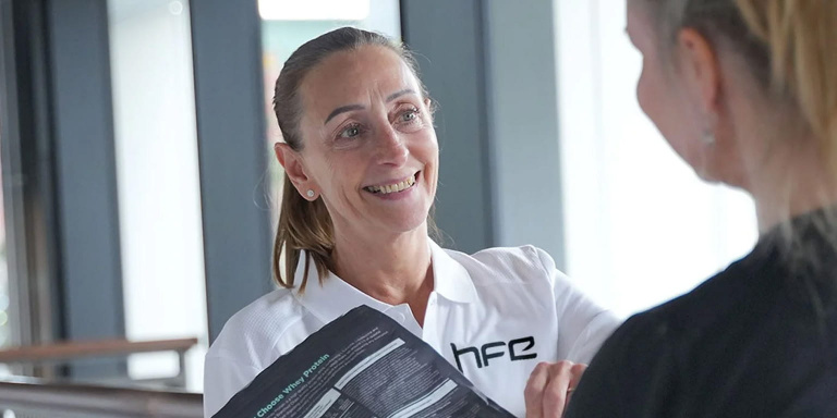 HFE tutor with client talking about protein powder