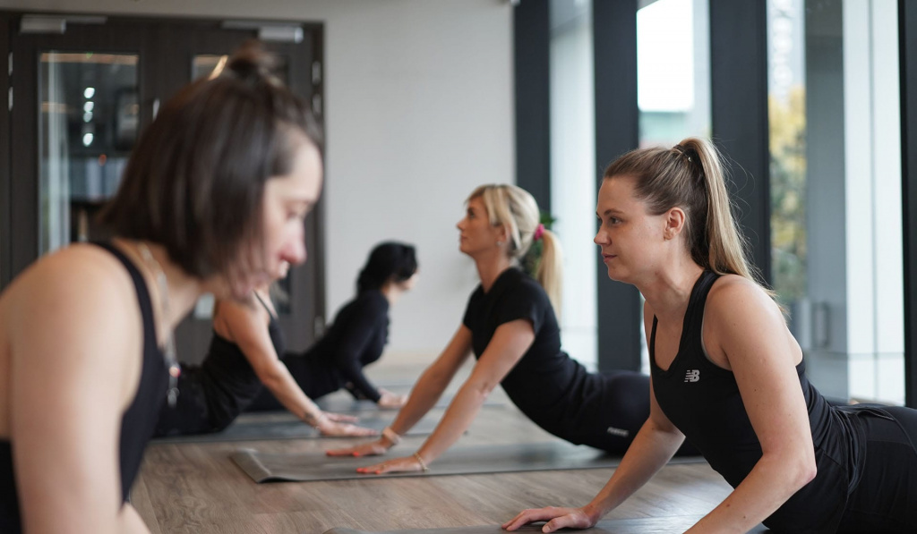 Students in a Pilates class completing the swan pose. Students in a Pilates class completing the swan pose.