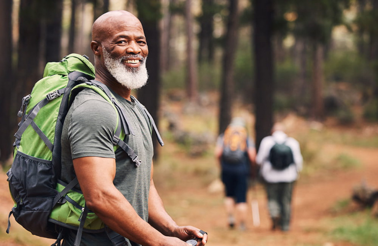 healthy man walking in the woods