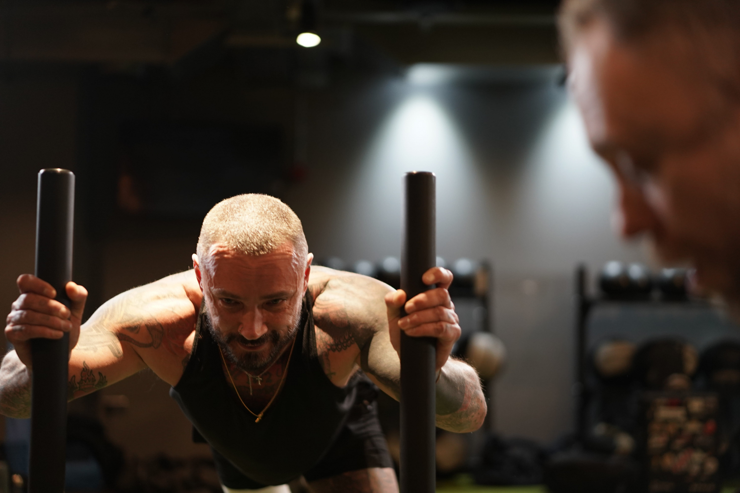 A male pushing a prowler in a gym
