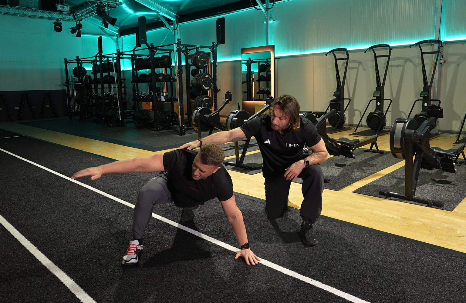PT Luke Worthington assisting a client in a gym