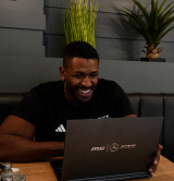 A male exercise professional sat in a cafe on a laptop A male exercise professional sat in a cafe on a laptop
