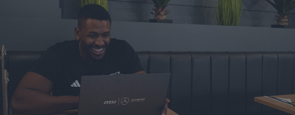 A male exercise professional sat in a cafe on a laptop A male exercise professional sat in a cafe on a laptop
