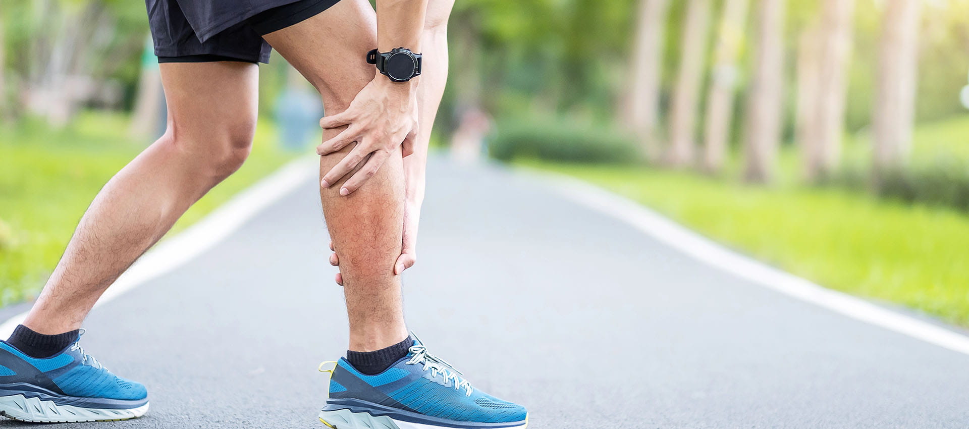 Runner holding shin in pain