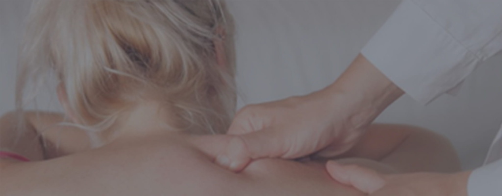 A massage therapist massaging a female client