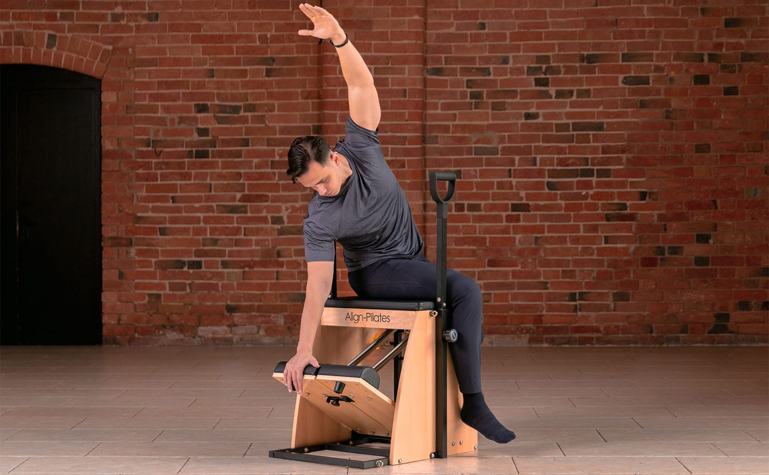 Man performing Pilates on a Pilates chair
