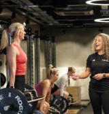 Woman in the gym with her personal trainer performing the deadlift Woman in the gym with her personal trainer performing the deadlift