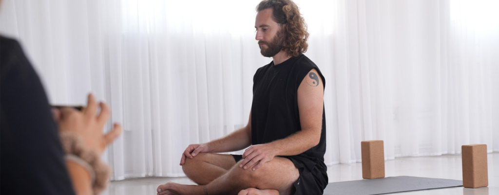Man practising kundalini yoga class Man practising kundalini yoga class